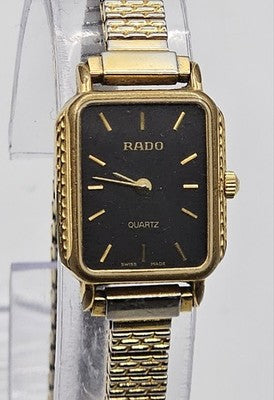 Rado Quartz watch with a rectangular face and a gold-tone band. Repair/Spare
