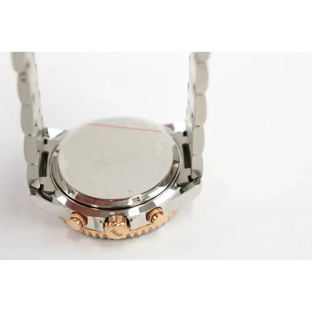 Close-up of the back of a stainless steel and rose gold watch with a metal link band, on a white background.