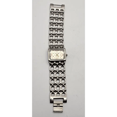 Silver watch with a chain-like metal strap on a gray background from our Pre-Owned & Secondhand Watches

