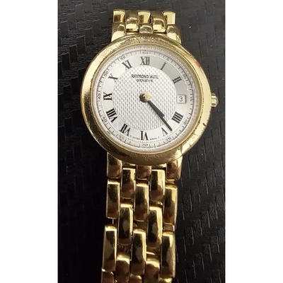 Gold wristwatch with a white face on a black textured background from our Pre-Owned & Secondhand Watches collection