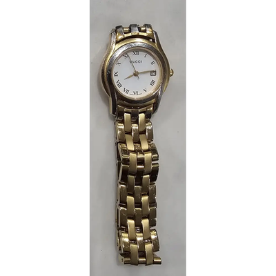 Gold watch with a white face on a gray background from our Pre-Owned & Secondhand Watches collection 