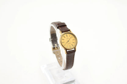 Wristwatch with brown leather strap and gold face on a white background from our Pre-Owned & Secondhand Watches collection 