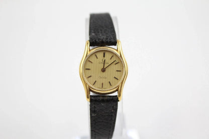 Vintage gold watch with black strap on a white background from our Pre-Owned & Secondhand Watches collection