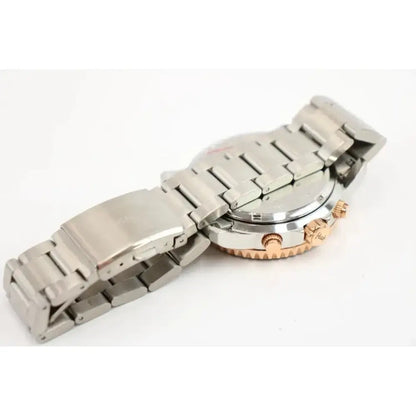 A stainless steel watch with a two-tone silver and rose gold case, shown from the back with the metal link bracelet folded over the side, on a white background.