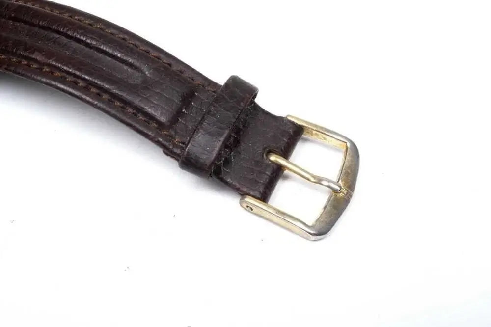 Antique rose gold watch with brown leather strap side view
