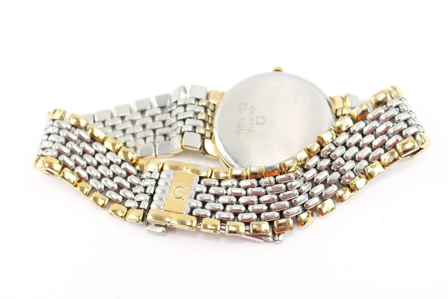 A two-tone stainless steel and gold watch band with a round silver-toned case, shown from the back on a white background.