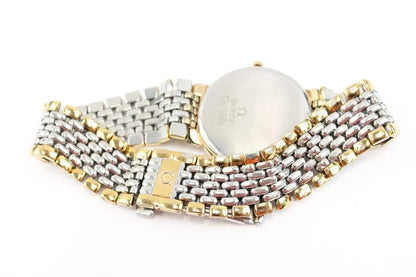 A two-tone stainless steel and gold watch band with a round silver-toned case, shown from the back on a white background.