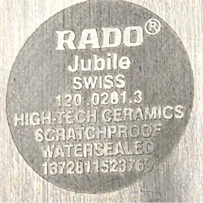 A close-up of a circular gray RADO Jubile high-tech ceramics scratchproof watersealed component on a light textured background.