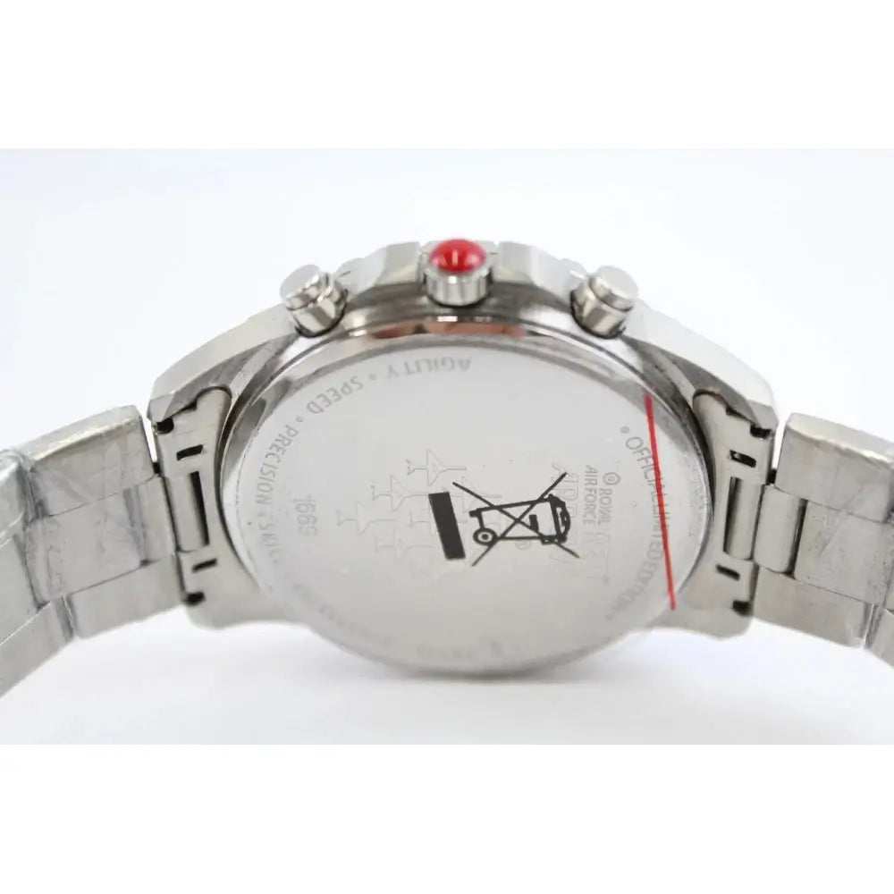Close-up of the back of a stainless steel wristwatch with a metal link bracelet, showing the case back, pushers, and a small red accent on the crown.