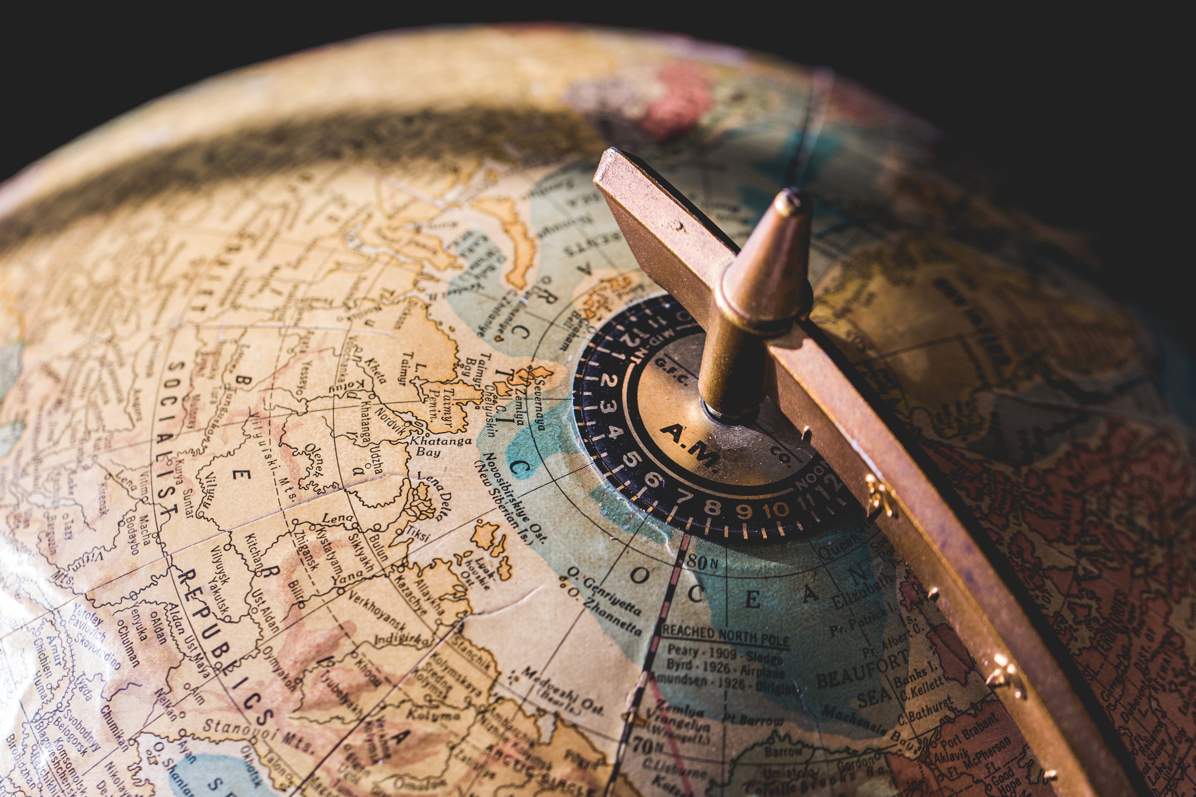 Vintage antique globe banner showcasing a curated collection of heirloom collectibles, estate jewelry, and historic medals.
