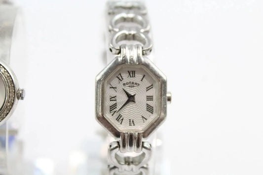 A silver-tone octagonal analog watch with a white dial, black Roman numerals, and a matching silver link bracelet, shown against a white background.