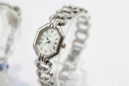 A vintage-style silver-tone watch with an octagonal bezel, white dial, and matching silver-tone chain bracelet, shown against a bright white background.